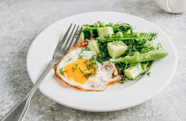 Healthy breakfast with eggs and cucumber salad with coffee on light gray background. Flat lay. Minimal concept