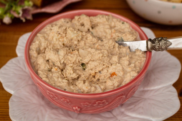 Homemade tuna pate in a vintage bowl on a rustic wooden table. Selective focus. Party concept.