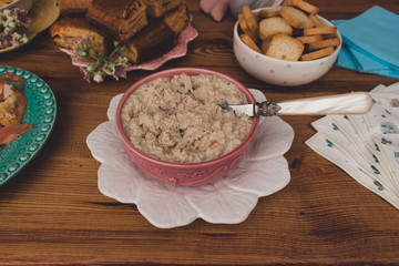 Homemade tuna pate in a vintage bowl on a rustic wooden table. Party concept.