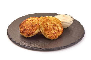 Freshly baked cottage cheese pancakes with sour cream, isolated on white background