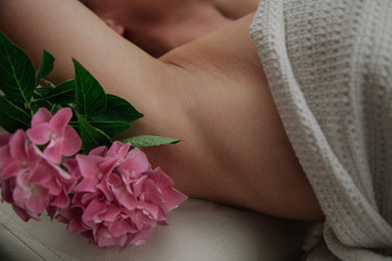 Obraz na płótnie Canvas Clean armpit with a flower on it. Beauty concept. Sugarig epilation concept. 