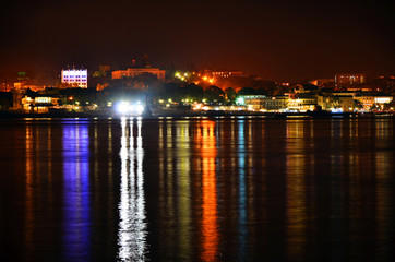 Lights of the night Sevastopol and their reflection in the sea