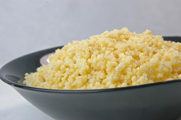 groats in plate on white