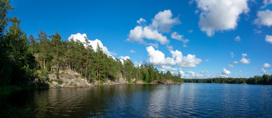 Fototapeta na wymiar Summer lake scene at hiking trail in Teijo national park, Salo, Finland. Trees and the Matildajarvi lake.