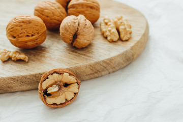 Walnuts on wooden surface, close-up. Source of vegetable protein. Healthy diet. Selective focus.