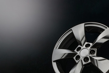 matte black alloy wheels on a dark background. concept for car shops and service stations, copy space