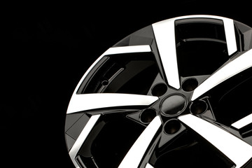 new alloy wheels on a black background. stylish and beautiful. auto parts and auto tuning