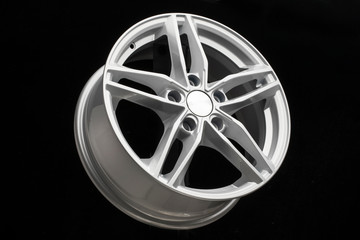 silver new alloy wheel in the form of a five-pointed star. black background