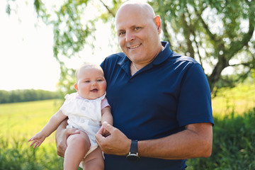 grandfather spending time with little baby girl during the day