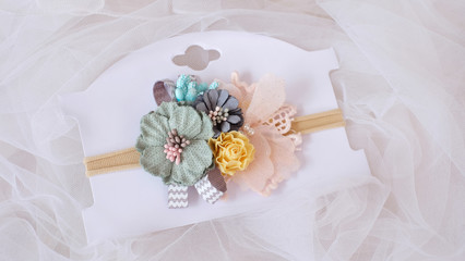 A bouquet of flowers made out of fabric cloth textile in beautiful pastel colors placed on card stock paper that can be used as hair accessory, decoration, and embellishment
