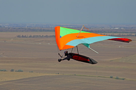CRIMEA, UKRAINE - SEPTEMBER 4: Competitor Victor Parhomenko of the Grininko hang gliding competitions takes part in the Klementieva mountain on September 4, 2012 in Crimea, Ukraine