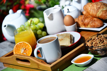 Breakfast served with coffee, juice, croissants and fruits