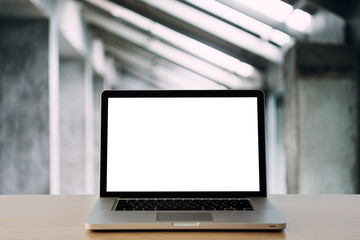 laptop with blank screen on wooden table.