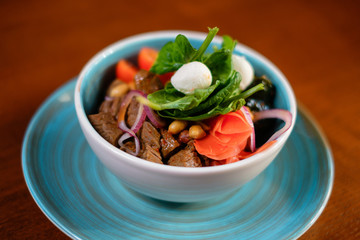 Fresh salad with meat, cheese, tomatoes and herbs. The concept of fast preparing healthy, tasty and hearty meals.