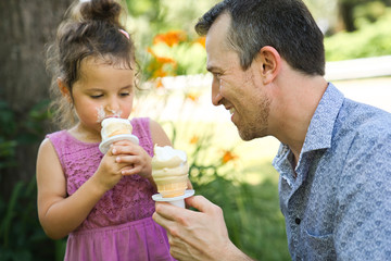 Fototapeta premium father with an ice-cream in the park with daughter