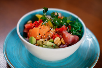 Fresh salad with seafood, cheese, parsley and herbs. The concept of fast preparing healthy, tasty and hearty meal.