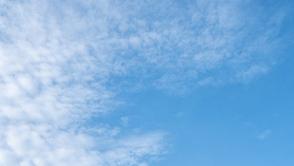 Blue sky with white clouds for text background.