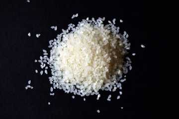 Pile of white rice for pilaf on a black background