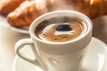 Cup of coffee and fresh croissants - italian or mediterranean breakfast