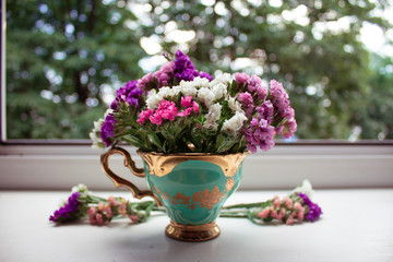 
cozy breakfast with charming flower tea in a beautiful cup