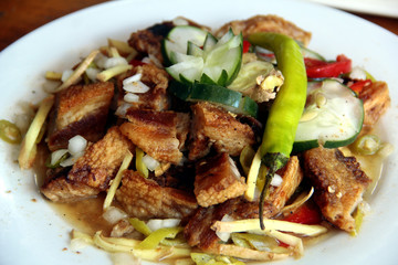Filipino dish called Dinakdakan or crispy pork meat in calamansi based sauce