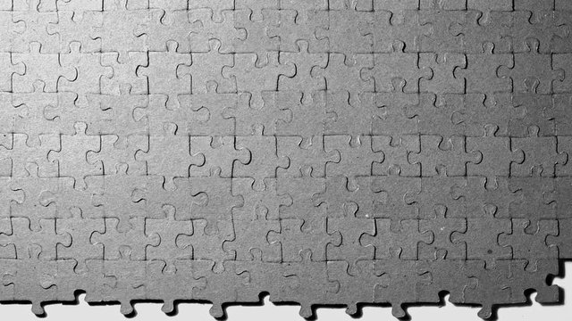 Assembling puzzles in rows. Stop motion.