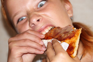 girl greedily eating pizza close up