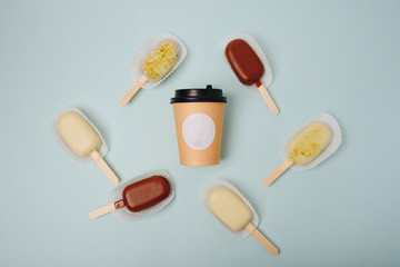 Chocolate cake in the form of ice cream on a stick on a white plate and a colored background