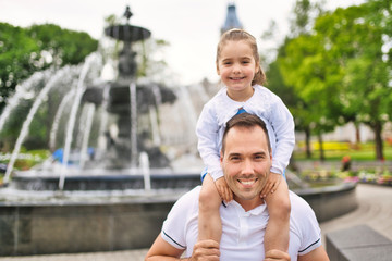 father and his cute daughter having fun outdoors