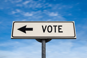 Vote road sign, arrow on blue sky background. One way blank road sign with copy space. Arrow on a pole pointing in one direction. Election.