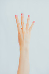 Woman's hand shows four fingers