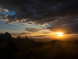 Desert sunset over a prominent rock formation