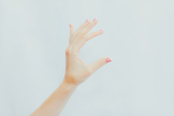 Woman's hand holds something in her fingers