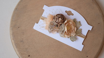 Bouquet of roses made out of fabric cloth textile in beautiful soft pastel brown theme colors placed on cardstock paper that can be used as hair accessory, decoration, and embellishment