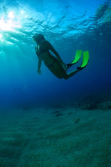 A young woman is diving