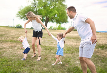 Happy young family outside in summer day