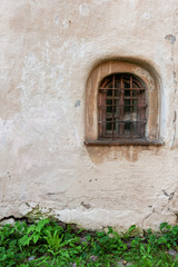 Fototapeta na wymiar Medieval window in an old plastered wall