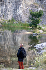 Fototapeta na wymiar Lonely traveler standing on the lakeside.