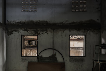 Abandoned room with two window was left to deteriorate over time, Abandoned house, Destroyed house, Ruined house. 