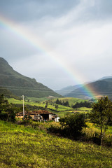 Beutiful natural landscape with a snowny mountain in the background with a amazing raimbow in the sky