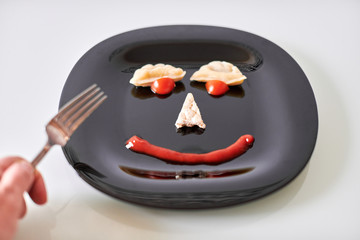 Funny food face, dumpling and ketchup