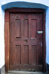 Old wooden door on a house in Viscri village from Transylvania, Romania.