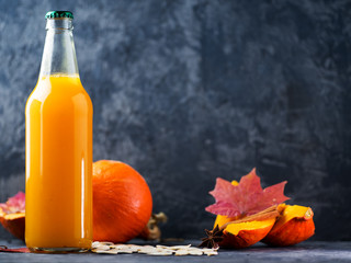 Bottle of homemade pumpkin juice, fresh pumpkin on the table with copy space. healthy natural drink