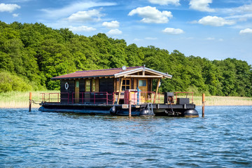 Fototapeta na wymiar Houseboat on the Grienericksee in Rheinsberg-Brandenburg, Germany