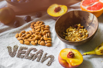 
Make a Balinese smoothie with banana, chia seeds, peach, plum, muesli, and coconut. Vegan lettering and heart made from almonds and chia seeds