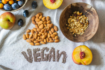 
Make a Balinese smoothie with banana, chia seeds, peach, plum, muesli, and coconut. Vegan lettering and heart made from almonds and chia seeds