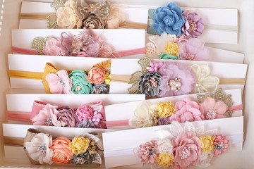 Handmade flower made out of fabric cloth textile in beautiful soft pastel colors that can be used as hair accessory, decoration, and embellishment