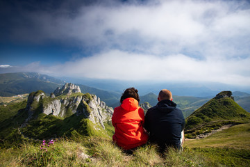 Fototapeta premium Young woman and man enjoying mountain view in Ciucas mountains, Romania.