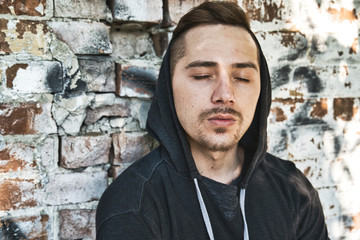 Fototapeta premium sad urban man with hood on head. Mystery man