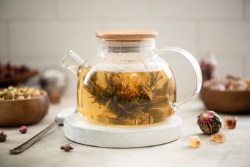 brewed tea flower in a glass teapot